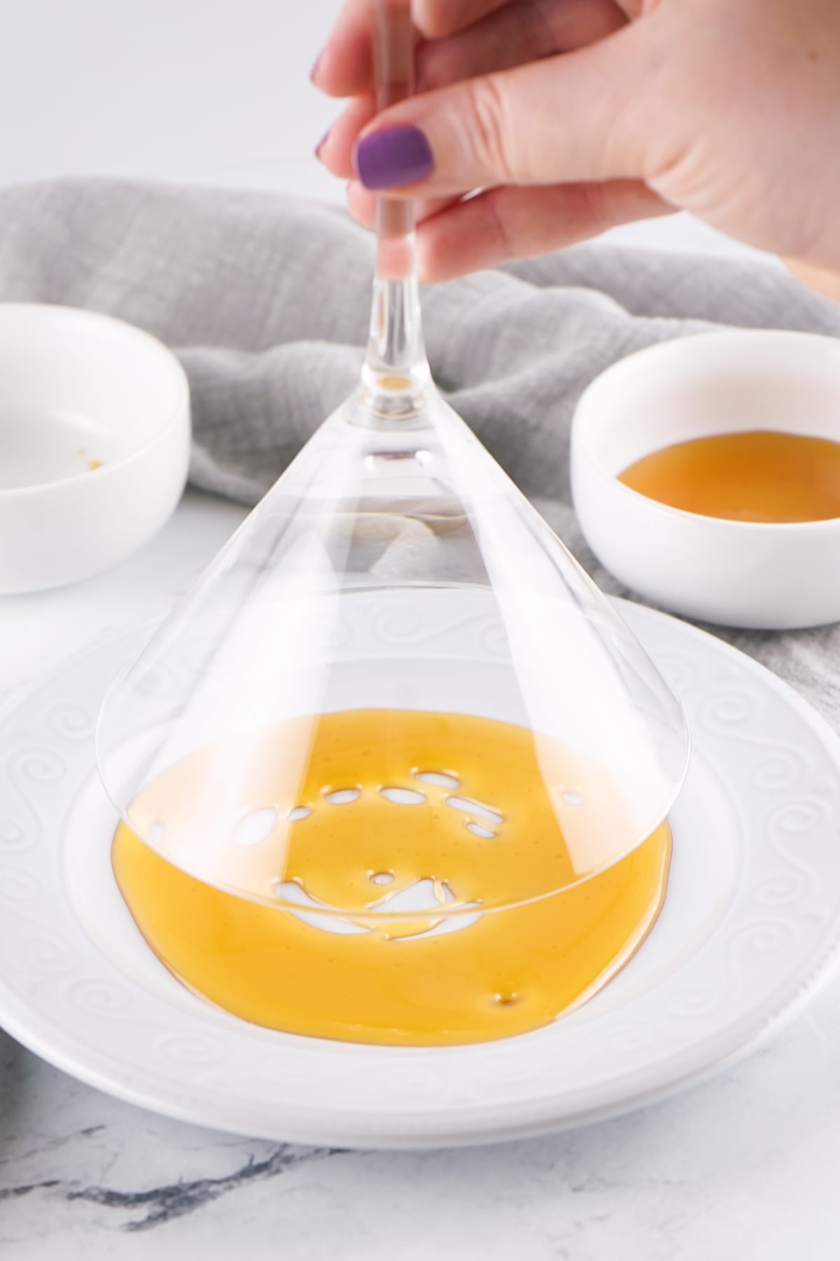 dipping glass into honey